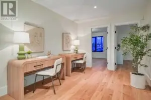a room with a desk and chairs