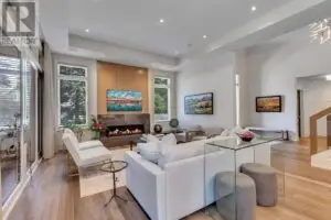 a living room with a fireplace and white furniture