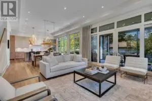 a living room with a large glass wall and a large window