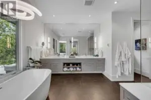 a bathroom with a tub and a large mirror