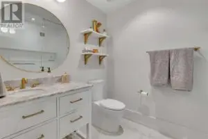 a bathroom with a round mirror and sink